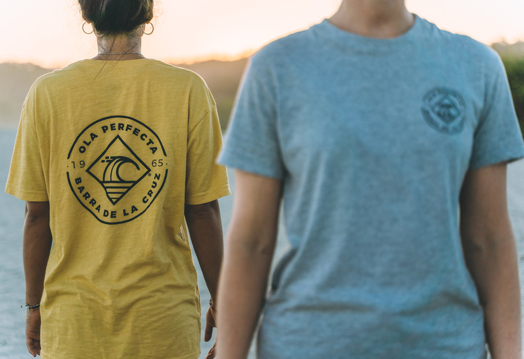 Surfer wearing OLA PERFECTA® apparel at Barra de la Cruz, Oaxaca.
